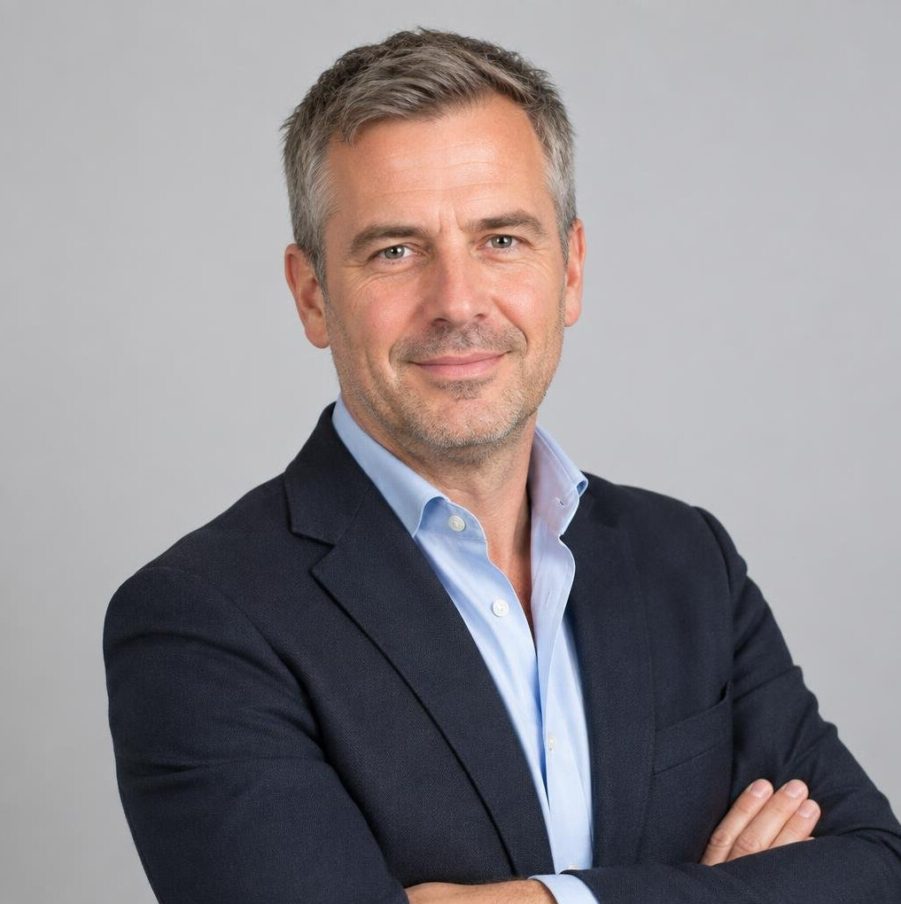 Belgian man in his 40s wearing a blazer, professional headshot