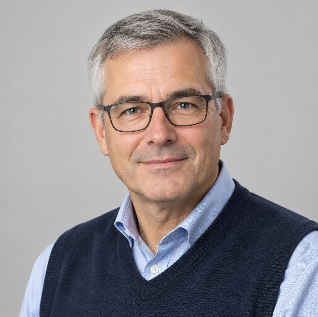 Belgian man in his 50s with glasses, professional headshot
